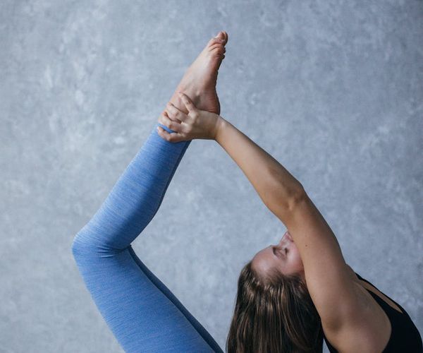 Person holding a balanced yoga pose demonstrating strength and focus.